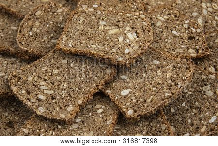 Slices Of Stacked Brown Bread. Food Background Or Texture