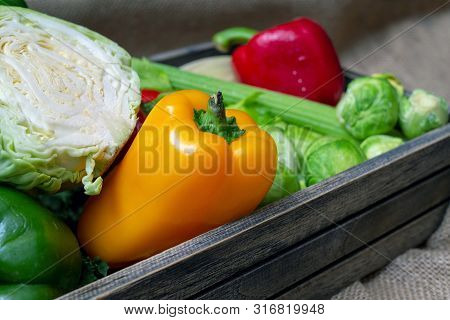 Various Non-toxic Fresh Vegetables Are Placed In A Wooden Box Placed On A Mat. Many Vegetables Are P