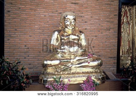 Ayutthaya / Thailand - Circa 2000: A Golden Sculpture Of A Fat Seated Buddha Sits In A Lotus Positio