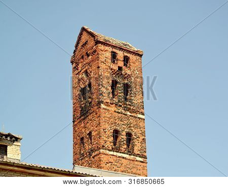 Fragment Of Clock Tower Of The Medal Ragnit Lock In The Summer. City Neman, Kaliningrad Region