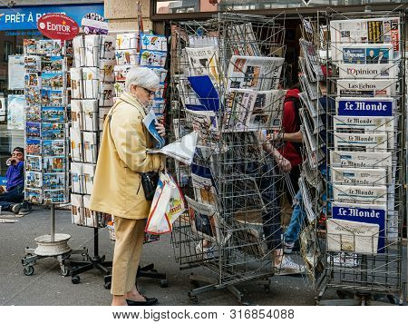 Strasbourg, France - May 25, 2019: Side View Of Senior Woman Reading German Taz Newspaper At Press K