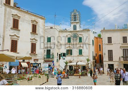 Polignano A Mare, Italy - July 28, 2019: View Of Main Square With Clock Tower Landmark In Polignano 