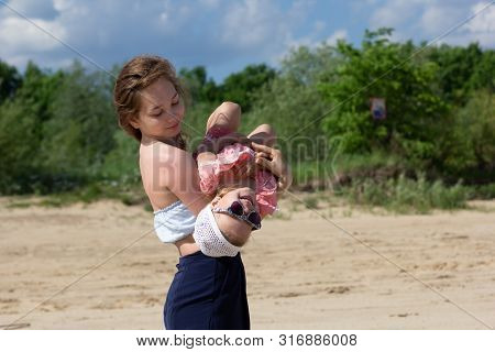 Young Woman Hugging A Child With Love And Tenderness
