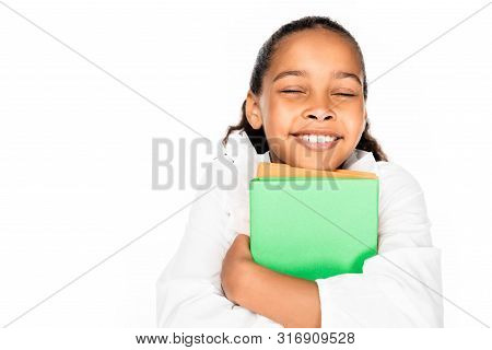Happy African Ameican Schoolgirl Smiling With Closed Eyes While Holding Books Isolated On White