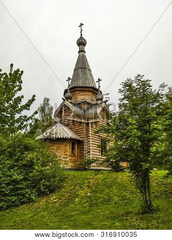 Church Against A Gray Sky With Trees