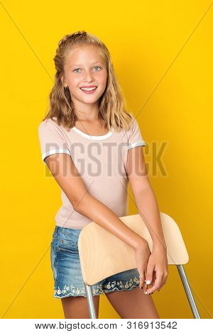 Stylish Pretty Teen Girl Posing Over Yellow Background. Summer Fashion. Healthy Perfekt Skin. Beauty
