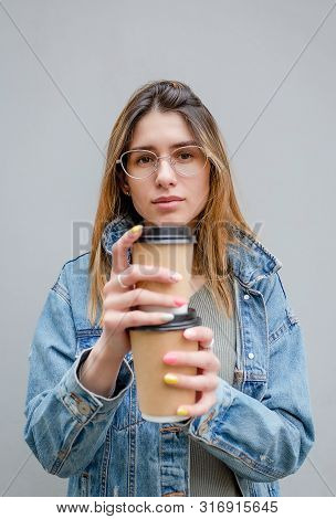 Blonde Girl With Paper Cups Of Coffee On Grey