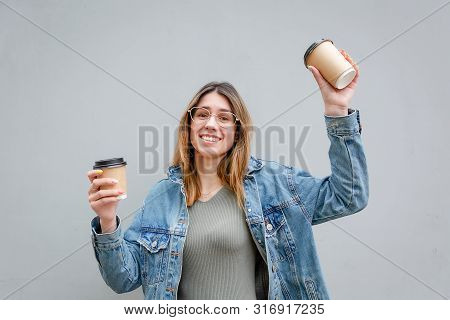 Blonde Girl With Paper Cups Of Coffee On Grey