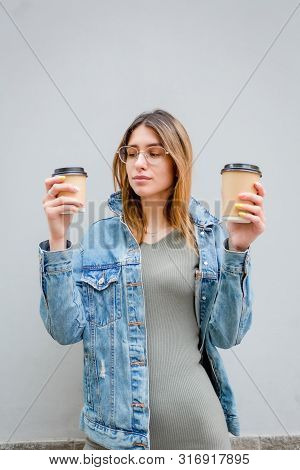 Blonde Girl With Paper Cups Of Coffee On Grey