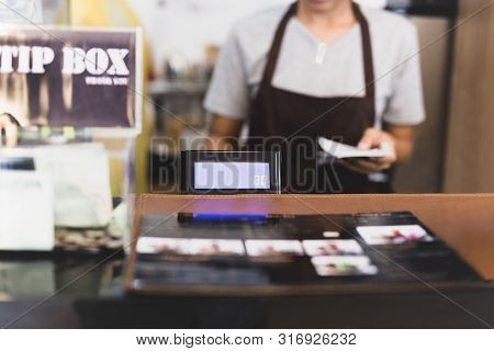 Selected Focus Cashier Register With Female Waitress Operating In Cafe.
