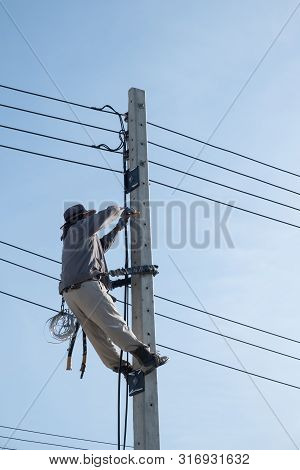 Electricty Power Lines Man Climbing.