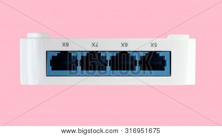 White 8 Port Plastic Ethernet Switch Isolated On Pink Background At Dry Day