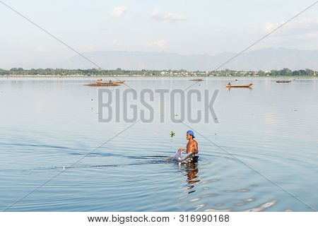 Mandalay, Myanmar - 03 December, 2018: Horizontal Picture Of Local Burmese Fisherman Fishing With A 