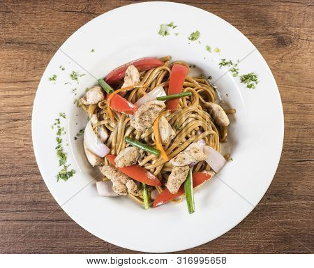 Tallarin Saltado Traditional Peruvian Meal. Peru. On A White Plate