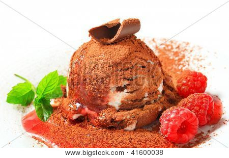stracciatella ice cream sprinkled with cacao and decorated with fresh raspberries