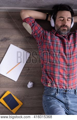 Man relaxing on floor thinking idea solitions. Man lying or student studying online lesson. Creative inspiration study concept
