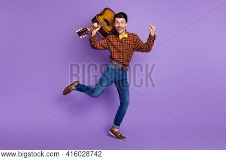 Photo Of Funky Crazy Musician Guy Hold Guitar Dance Wear Bow Tie Plaid Shirt Jeans Shoes Isolated Pu