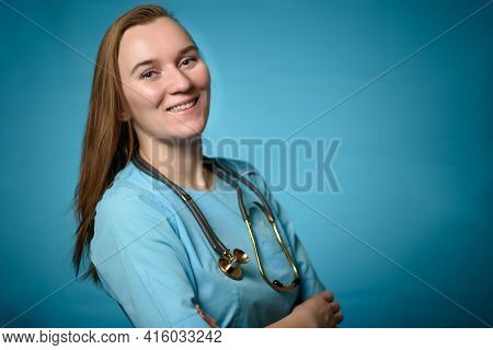 A Doctor On A Blue Background Holding A Stethophonendoscope