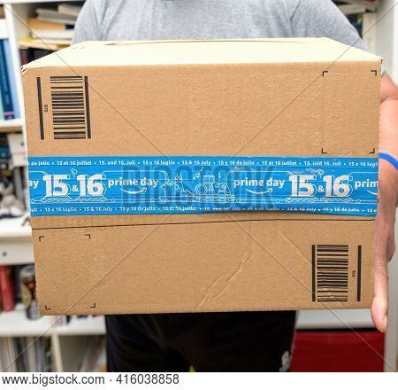Paris, France - Oct 10, 2019: Senior Hands Holding New Amazon Prime Parcel Logotype With The Smiling
