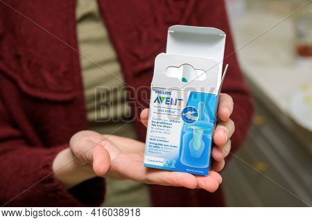 Paris, France - Feb 21, 2021: Young Mother Woman Showing The Unboxed Cardboard Box With Philips Aven