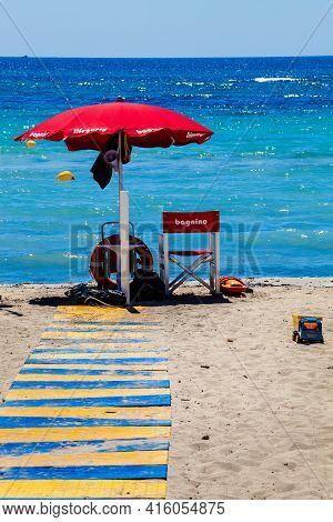 Lifeguard (italian: Bagnino). Sea And Lifeguard Station With Umbrella. Beach With Bright Colors And 