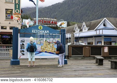 Ketchikan, Alaska / Usa - August 15, 2019: Tourist Looking Ketchikan Map, Ketchikan, Alaska, Usa