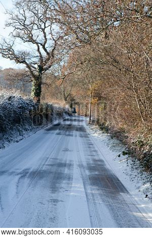 A Country Lane In The Snow On A Sunny Day