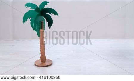 Rtificial Palm Tree And Rainbow Soap Bubbles On A White Wooden Table. Relaxation And Imagination Con
