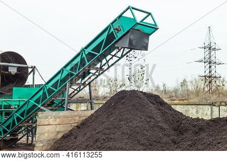 Producing Soil At Industrial Compost Plant. Sifting Soil With A Machinery To Make Clean Earth Ready 