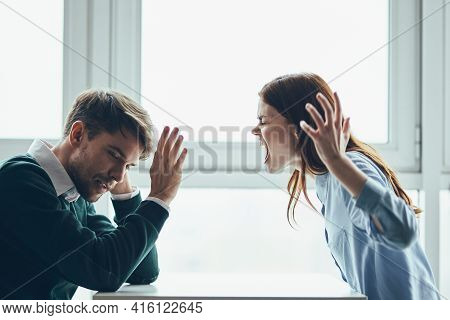 Emotional Man And Woman Sitting At The Table Conflict Quarrel Communication