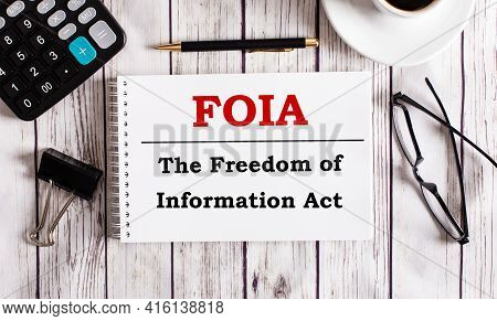 Foia The Freedom Of Information Act Is Written In A White Notepad Near A Calculator, Coffee, Glasses