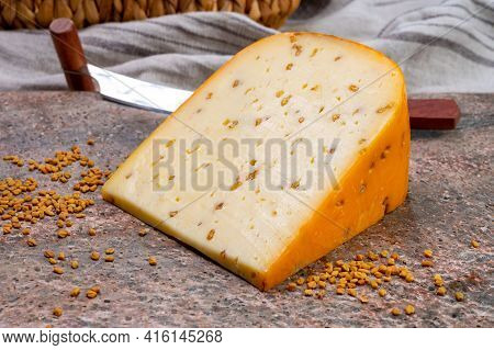 Cheese Collection, Piece Of Hard Yellow Dutch Gouda Cheese With Dried Fenugreek Seeds