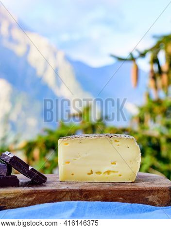 Cheese Collection, French Tomme De Savoie Or Tome Des Bauges Cheese And Dark Chocolate Served Outdoo