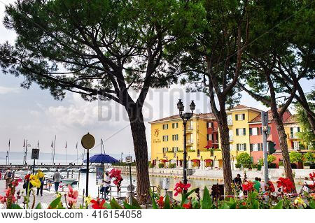 Sirmione, Italy-october 9, 2018: People Relax In The Town Of Sirmione Near The Castle Of Scaligera
