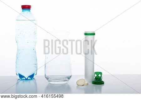 Drinking Water Bottle, Glass And Vitamins. Glass With Water And Pills. White Background.