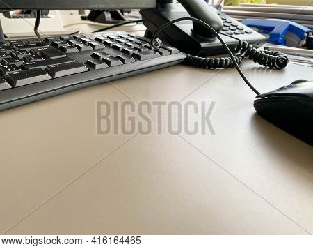 Black Modern Computer Mouse Keyboard And Telephone On A Working Office Table In A Business Company