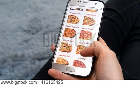Mogilev, Belarus-march 23, 2021: Woman Holds A Close-up Mobile Phone With A Pizzeria Website On The