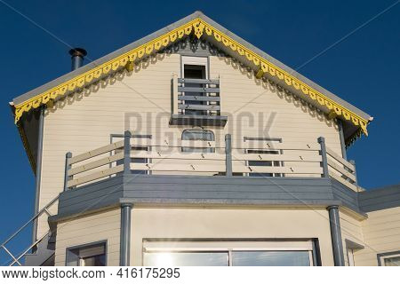 Colorful Wooden Beach House Facade In Brittany, France With Blue Sky. France