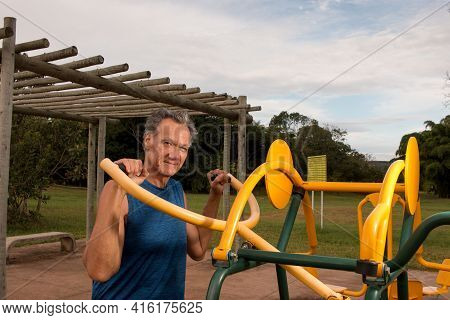 Senior Man Working Out At An Outdoor Fitness Park In Parque Das Garças, Brasilia