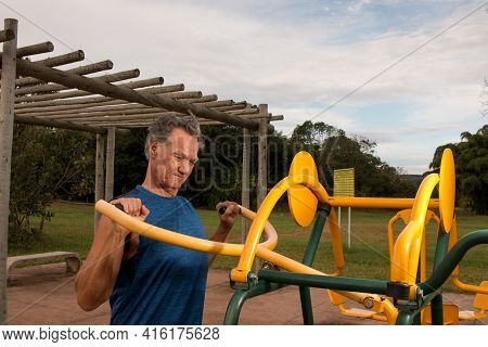 Senior Man Working Out At An Outdoor Fitness Park In Parque Das Garças, Brasilia