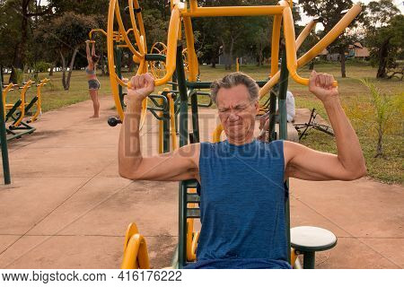Senior Man Working Out At An Outdoor Fitness Park In Parque Das Garças, Brasilia
