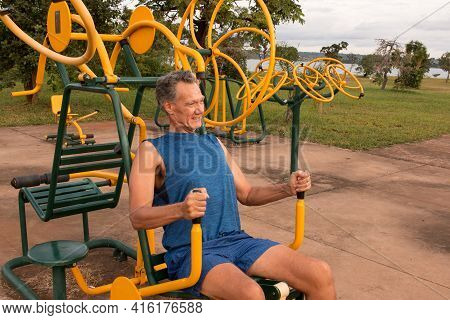 Senior Man Working Out At An Outdoor Fitness Park In Parque Das Garças, Brasilia