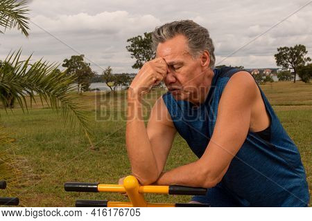 Senior Man Working Out At An Outdoor Fitness Park In Parque Das Garças, Brasilia