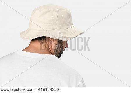 Man wearing bleached bucket hat, rear view