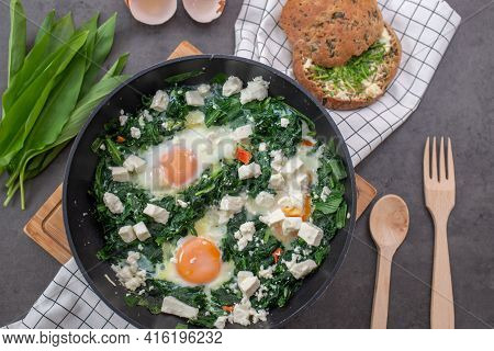 Green Shakshuka. Fried Eggs With Wild Garlic And Feta Cheese