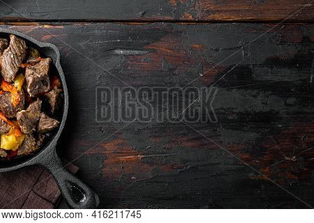 Mongolian Beef, Pieces Of Beef Stewed In Soy Sauce Set, In Cast Iron Frying Pan, On Old Dark  Wooden