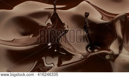 Hot chocolate waves, melted chocolae mixing.