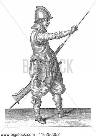 A soldier, to the right holding a rudder (a particular type of firearm) with his left thigh with his left hand and pulling his ramrod out of the barrel with his right hand, vintage engraving.