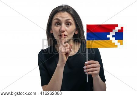 Happy Young White Woman Holding Flag Of Nagorno-karabakh Republic And Holds A Finger To Her Lips Iso