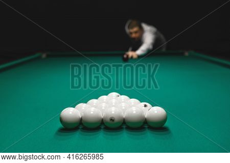 Focus On The Pile Of White Billiard Balls And Hand Of A Man In A White Shirt Aiming For A Kiy. Draw 